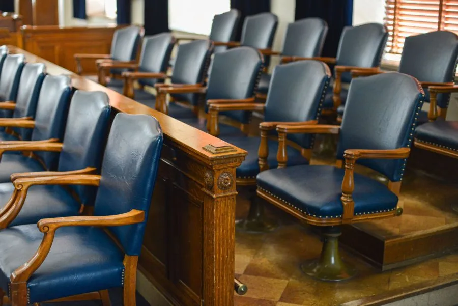 Jury seating area with arranged leather chairs in a courtroom, showing results of government cleaning services.