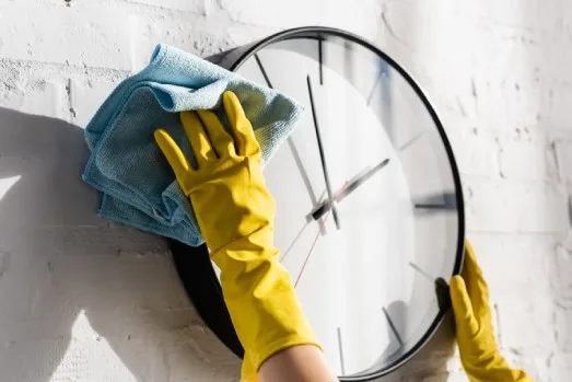 Cleaning Plans Cleaning a modern black-framed clock
